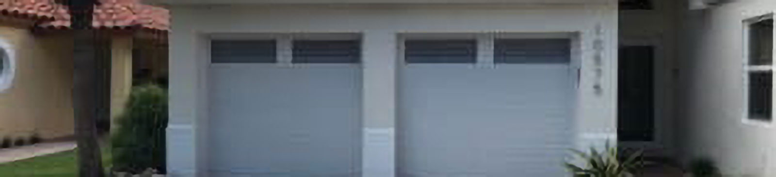 Wide view of new double grey sectional garage door after installation on a Citrus Heights, CA home.